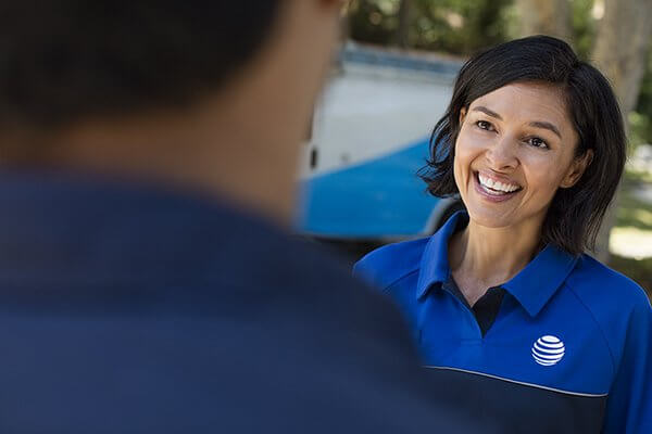 woman in at&t uniform smiling while talking with client
